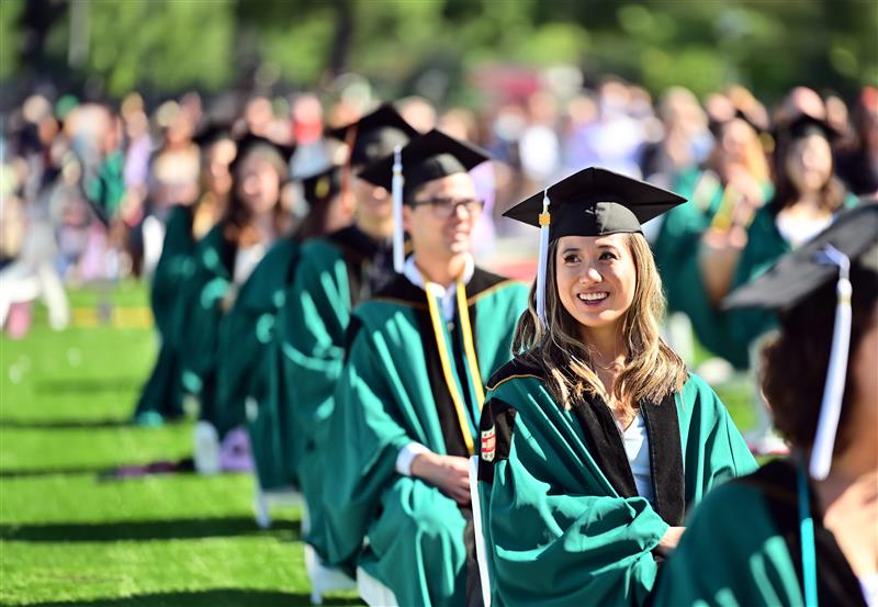 woman smiling at commencement ceremony